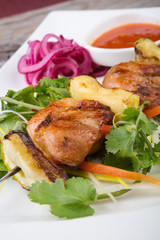 Fried meat on a metal skewer