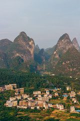 Obraz premium The view of the cityscape and karst rock mountains in Yangshuo, Guilin region, Guangxi Province, China.