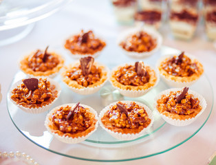 The sweety cakes stand on the buffet table