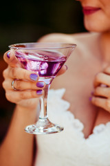 The bride keeps a glass of champagne