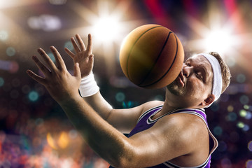 Fat Basketball non professional player catch the ball. Bokeh background