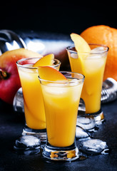 Cocktail with mango and orange liqueur, dark background, selecti