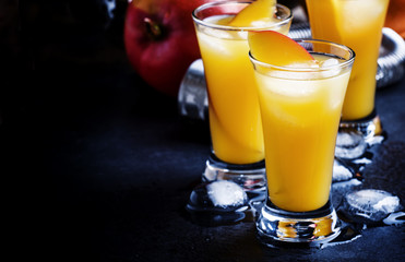 Cocktail with mango and orange liqueur, dark background, selecti
