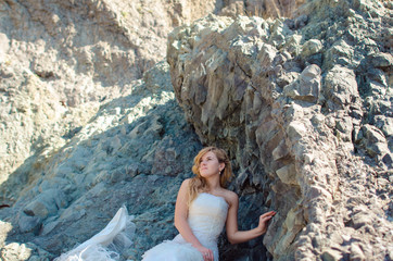 Beautiful bride posing in high mountain scenery