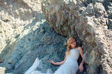 Beautiful bride posing in high mountain scenery