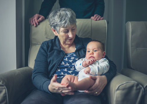 Grandparents at home with grandchild