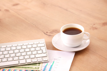 Obraz na płótnie Canvas on the desktop computer and a cup of coffee