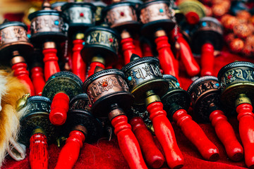 Tibetan prayer wheels on the street market near Kumbum Monastery in Lusar, Qinghai province, China