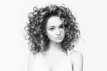 Fashionable and beautiful girl with curl hair. Perfect make-up