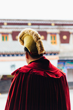 QINGHAI, CHINA - October 4, 2016: Tibetan monk wearing Yellow Hat (Gelug) in the ancient temple building architecture of Kumbum monastery in Qinghai Province, China