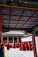 QINGHAI, CHINA - October 4, 2016: Tibetan monks in the ancient temple building architecture of Kumbum monastery in Qinghai Province, China