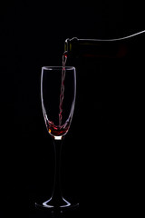 Wine glasses with wine bottle on a black background, minimalism,