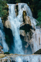 The colorful details of Kuang Si Waterfalls surrounded by a rainforest  in Luang Prabang, Laos.