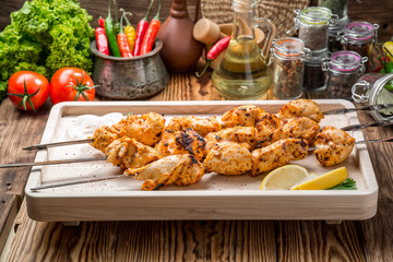 Assorted delicious grilled meat with vegetable on white plate  picnic table for family bbq party