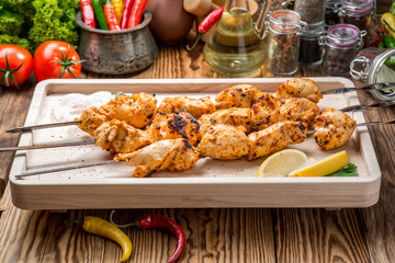 Assorted delicious grilled meat with vegetable on white plate  picnic table for family bbq party