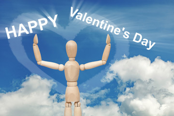 Wooden dummy puppet on sky with words VALENTINE'S DAY
