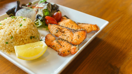 Grilled Salmon with fried rice , mixed salad and lemon