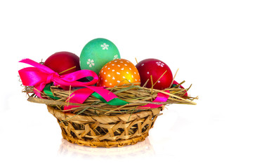 basket with Easter eggs on a white background