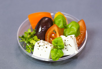Mini desserts and meat canapes vegetable snacks in plastic cups canapes