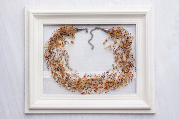 beaded necklace from colorful beads in the white frame