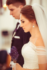 Fototapeta premium The brides hold hands in the church