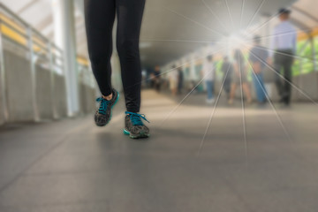 Fototapeta premium The legs of a woman wearing Legging fitness wear sports shoes ru