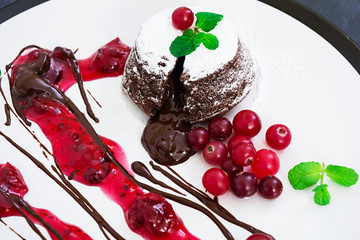 Chocolate fondant with cranberry sauce.