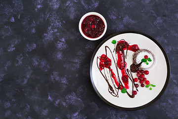 Chocolate fondant with cranberry sauce. Top view.