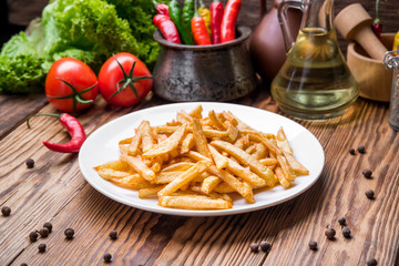 Tasty french fries on cutting board,  wooden table