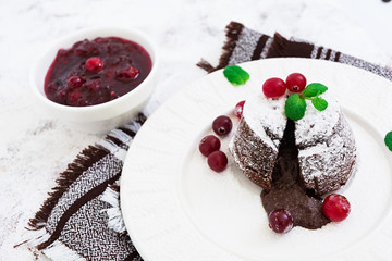 Chocolate fondant with cranberry sauce.