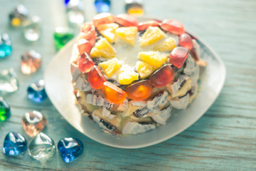 Homemade cake on a platter on a wooden board