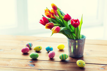 close up of easter eggs and flowers in bucket