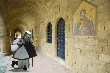 Medieval knight praying in cloistered in Filerimos Monastery in Rhodes Island built by the Knights...
