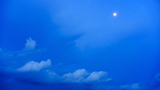 Moon and clouds in blue hour