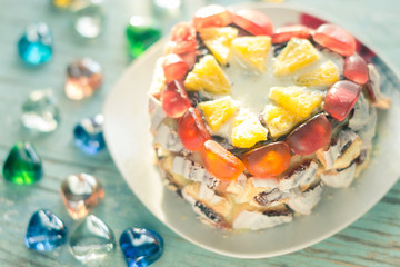 Homemade cake on a platter on a wooden board