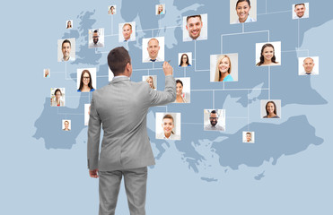 businessman at virtual screen with contacts