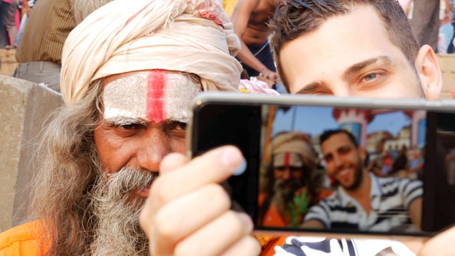 Tourist taking a selfie with Sadhu Holy Man in India