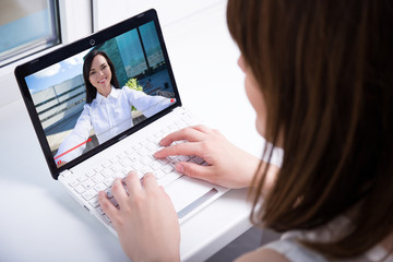 Fototapeta na wymiar young woman watching video blog on laptop