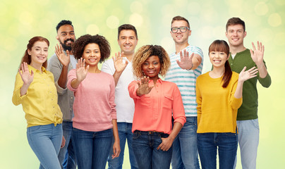 international group of happy people waving hand