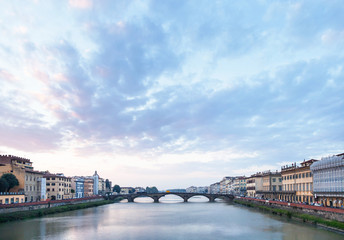 Fototapeta na wymiar blue clouds over Arno River and Ponte alla Carraia