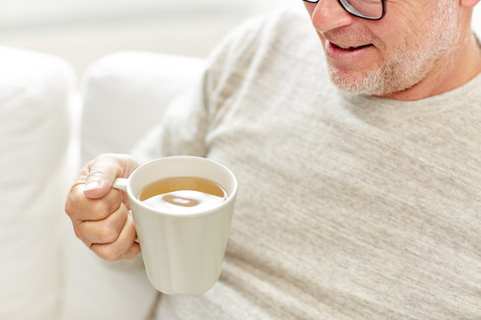 Close Up Of Happy Senior Man Drinking Tea At Home