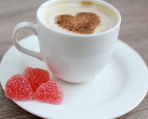 Cup of cappuccino with heart pattern of cinnamon