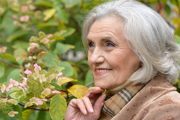 Beautiful middle-aged woman in autumn park