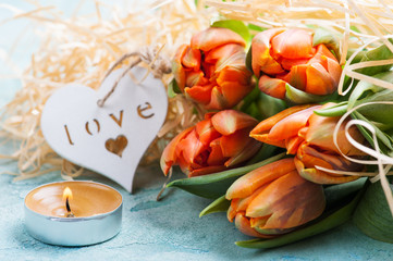 Orange tulips with wooden heart