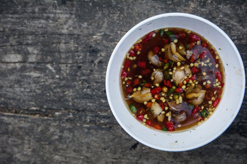 Chili with fish sauce on wooden table. Chili sauce. Thai chili sauce on table. Thai chili sauce. (wooden background)