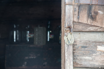 Old padlock on wooden gate
