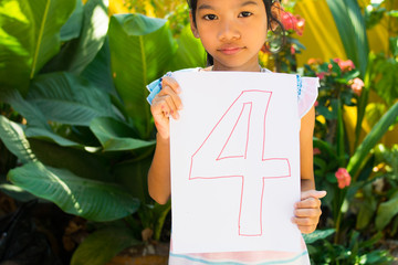 number concept,girl holding number four on white paper