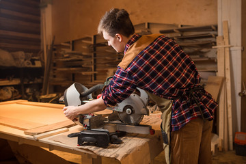 Carpenter is studying,works with the tools without protection