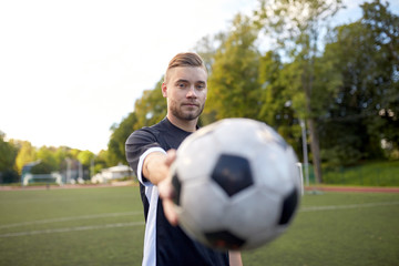 soccer player with ball on football field