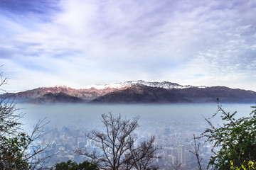 SANTIAGO, CHILE: Aerial view of a smog in a city with mountain in the background, Andes.